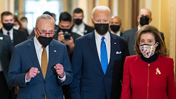 Joe Biden walks with Senate Majority Leader Chuck Schumer, D-N.Y., and House Speaker Nancy Pelosi, D-Calif., as he arrives to deliver remarks in National Statuary Hall on the one-year anniversary of the Jan. 6 attack on the U.S. Capitol, Thursday, Jan. 6, 2022, in Washington, D.C. (Official White House photo by Adam Schultz)