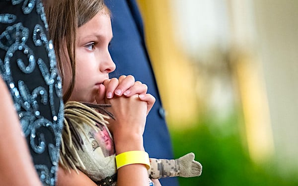 Brielle Robinson, daughter of Sgt. First Class Heath Robinson, listens during a signing ceremony for the 'Sergeant First Class Heath Robinson Honoring our Promises to Address Comprehensive Toxics (PACT) Act of 2022' Wednesday, Aug. 10, 2022, in the East Room of the White House. (Official White House photo by Erin Scott)