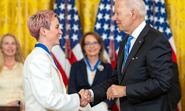 Joe Biden presents the Medal of Freedom to soccer player Megan Rapinoe, Thursday, July 7, 2022, in the East Room of the White House. (Official White House photo by Adam Schultz)