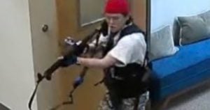 A woman identified as Audrey Hale stalks the Covenant School with a rifle on Monday in Nashville, Tennessee.