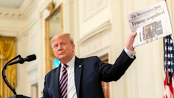 President Donald J. Trump shows a newspaper headline during his address Thursday, Feb. 6, 2020 in the East Room of the White House, in response to being acquitted in the U.S. Senate impeachment irial. (Official White House photo by D. Myles Cullen)